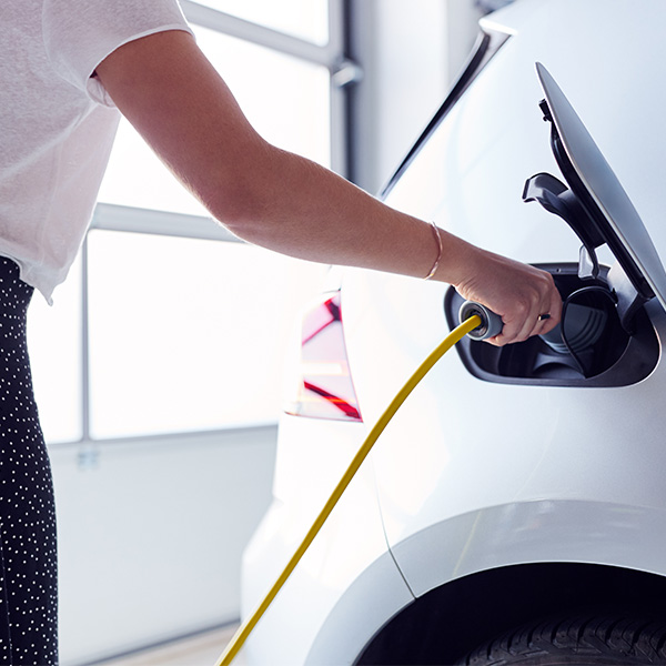 woman charging an electric vehicle